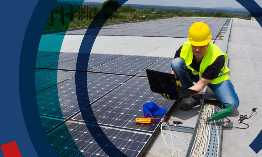 Man installing solar panels on roof